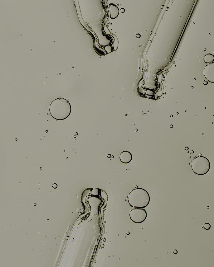 Close-up of oil and water droplets on a gray background