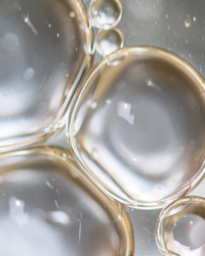 Close-up of clear bubbles on a reflective surface