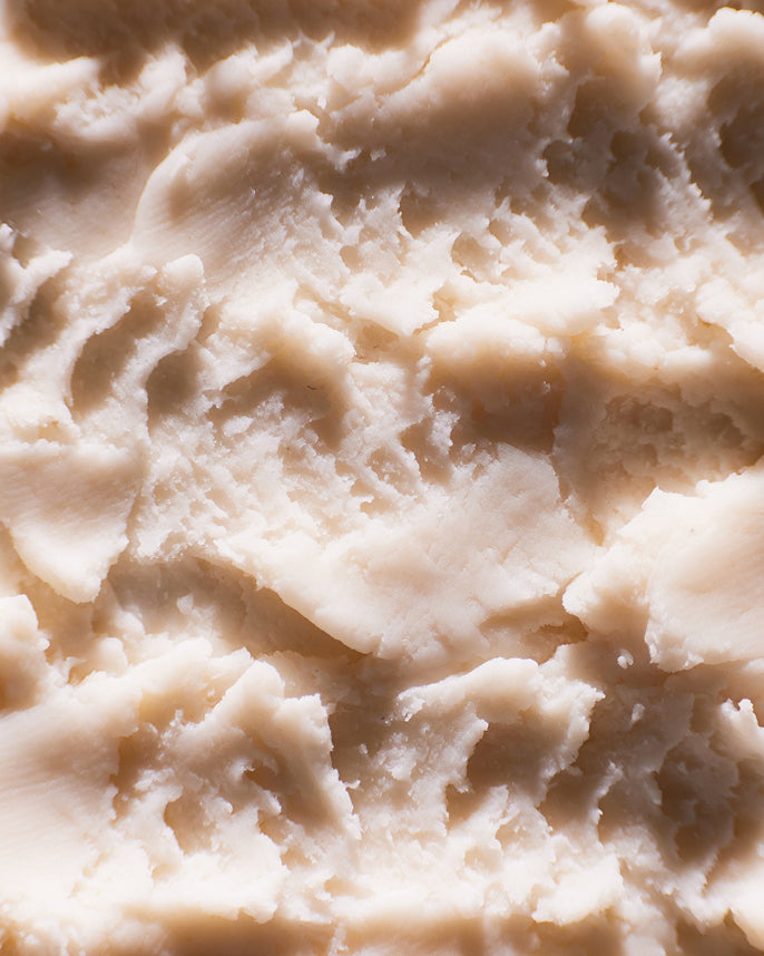 Close-up of a beige, creamy substance with a textured surface