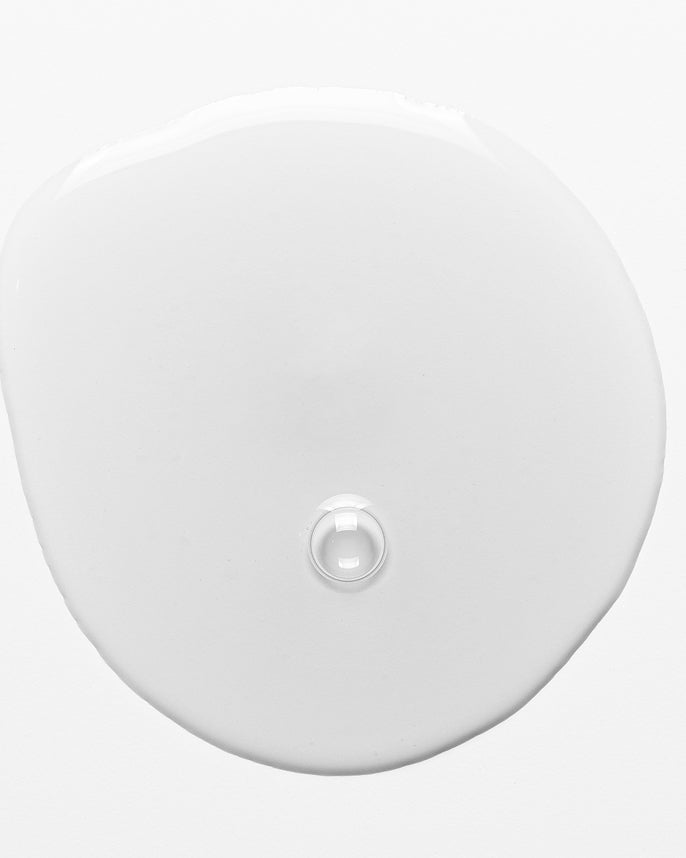 Round white object with a central indentation on a light gray background
