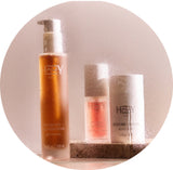 Set of skincare products with 'HPPY' branding on a beige background