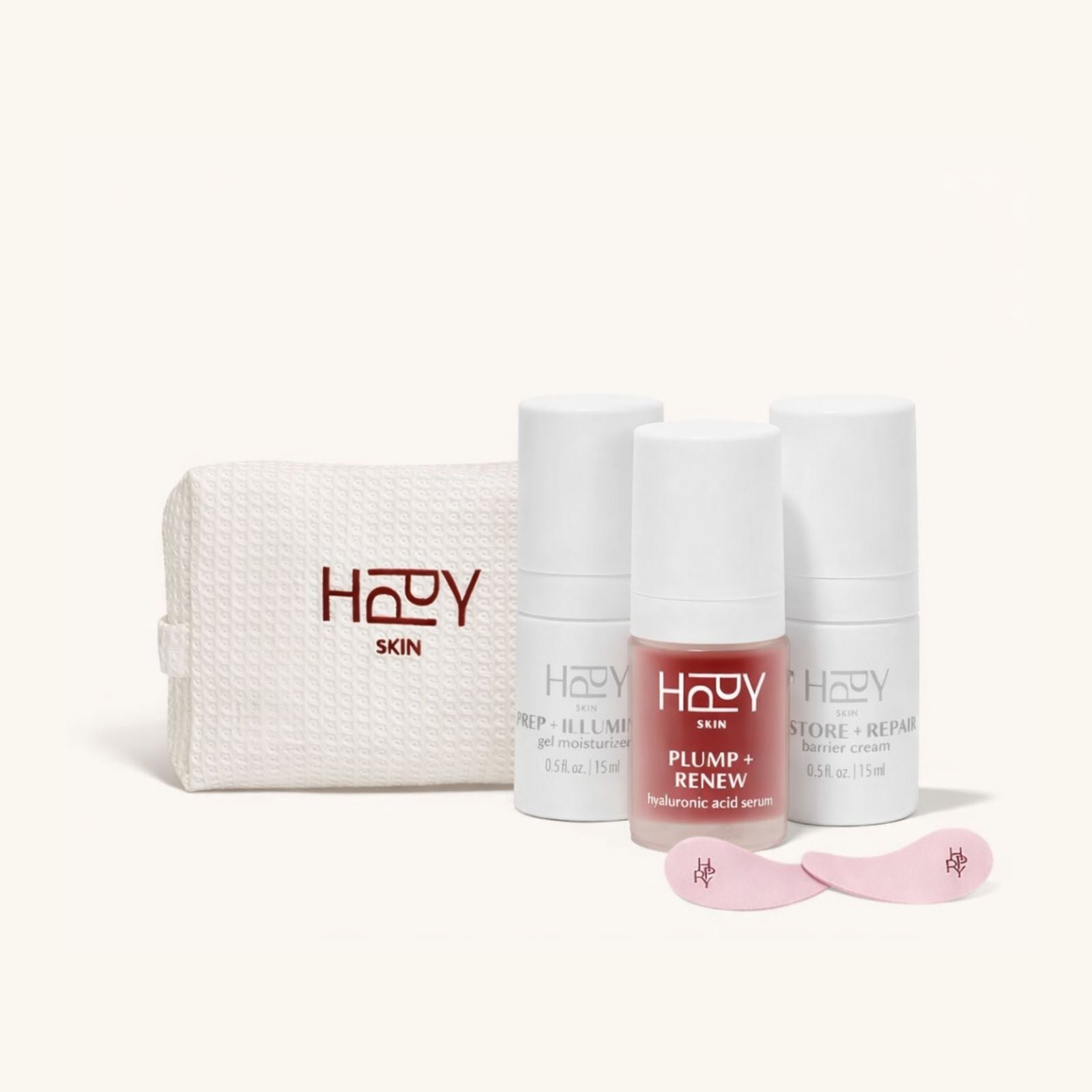 Set of HPPY skincare products including a pouch, bottles, and applicators on a white background