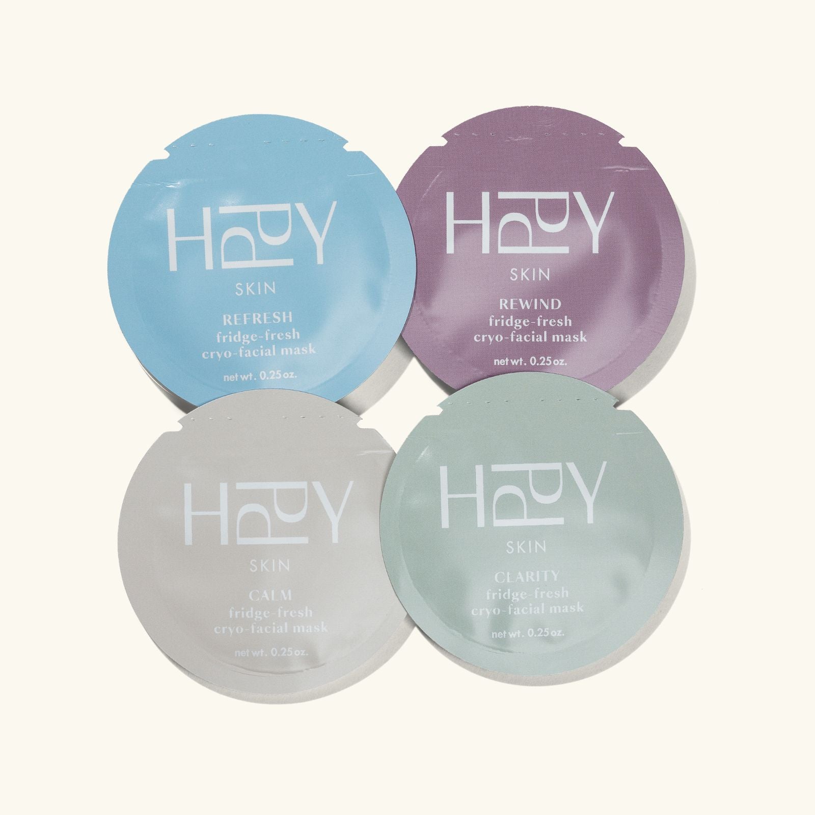 Four facial mask packets from the brand 'HPPY' on a white background