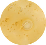 Round yellow object with a central indentation on a white background