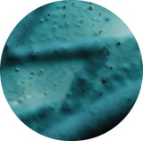 Close-up of a textured blue surface with small imperfections