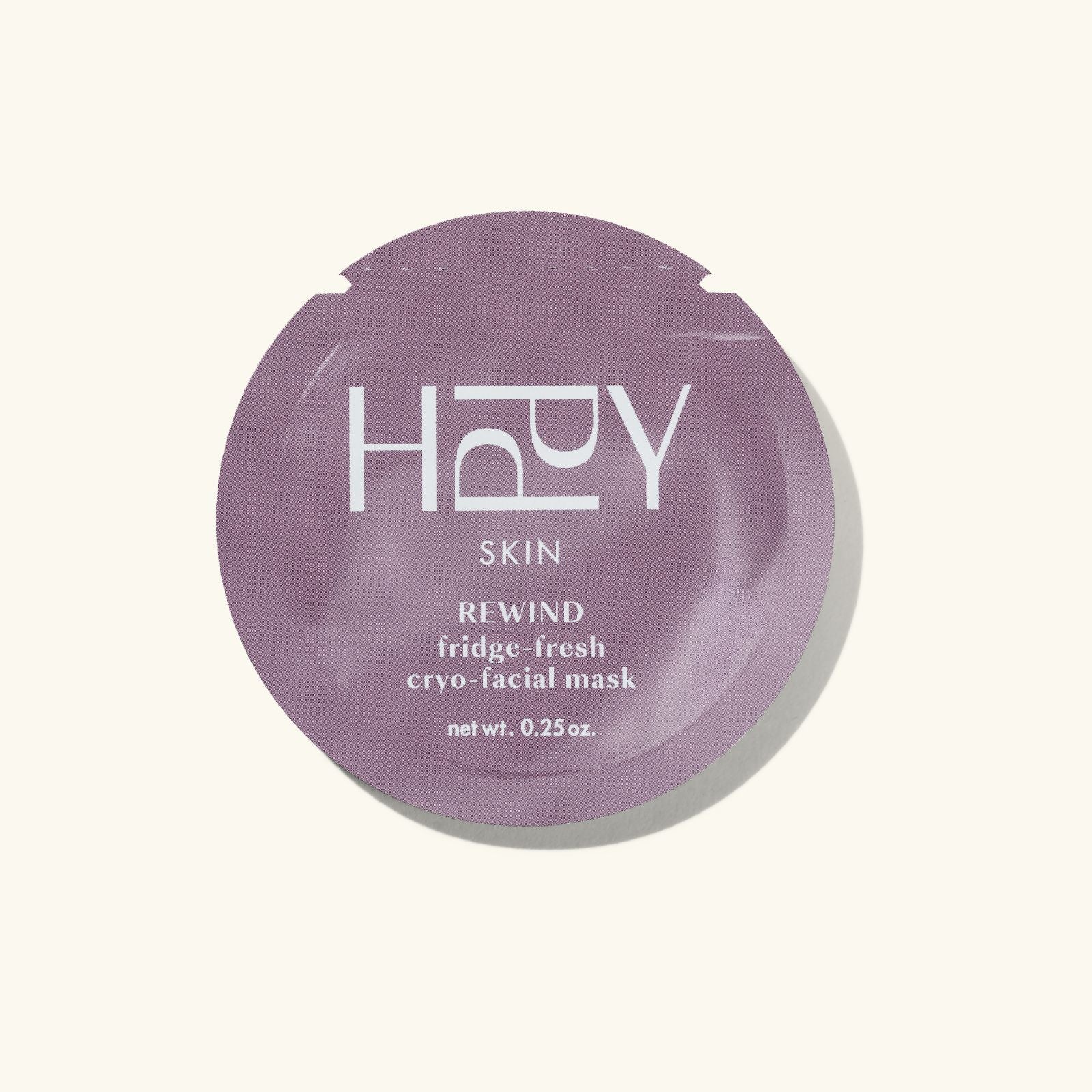 Purple facial mask container with 'HPPY resolution' branding on a white background