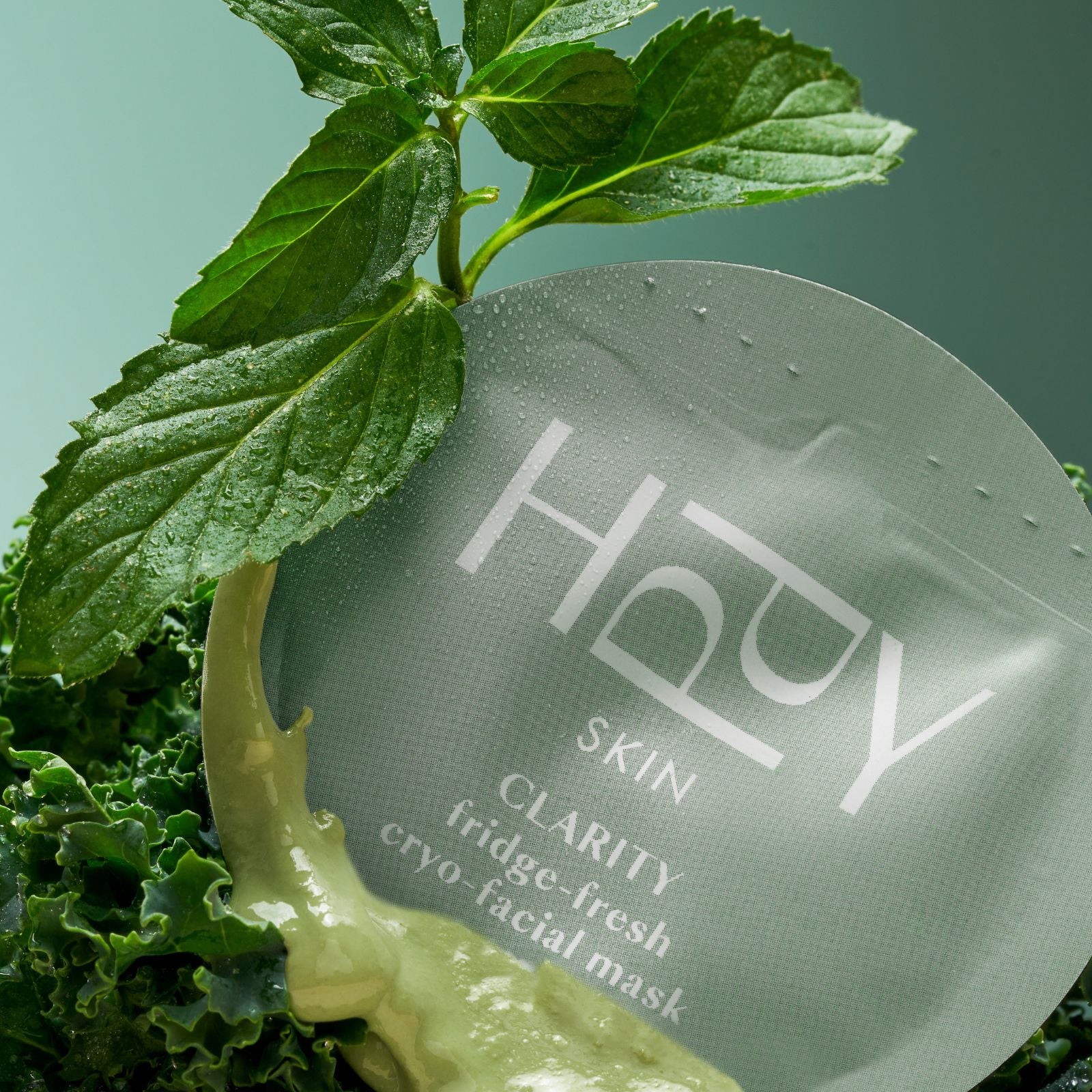 HPPY Skin Clarity cryo-facial mask packaging with green leaves on a light green background