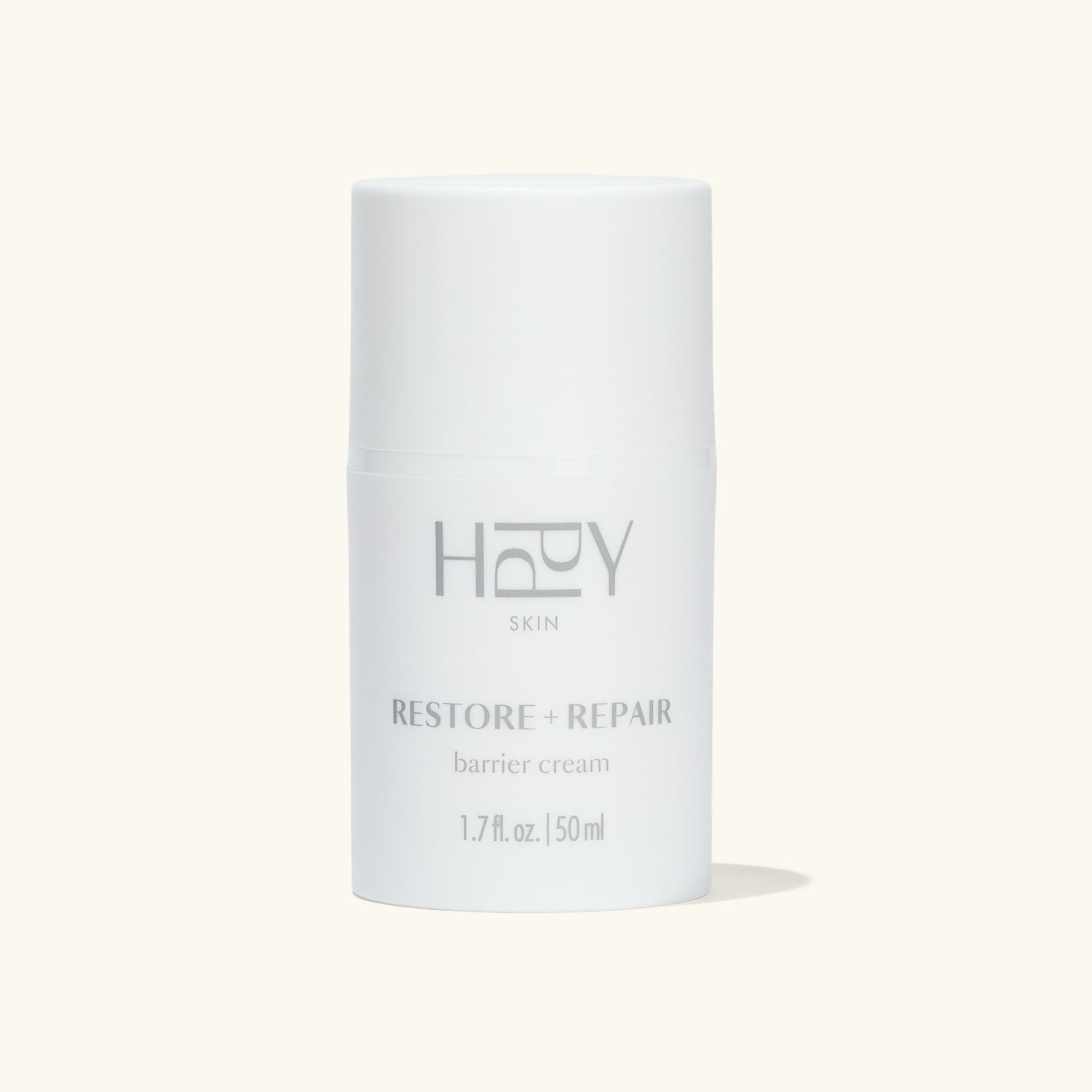 White cylindrical container of HPPY Skin Restore + Repair barrier cream on a light gray background