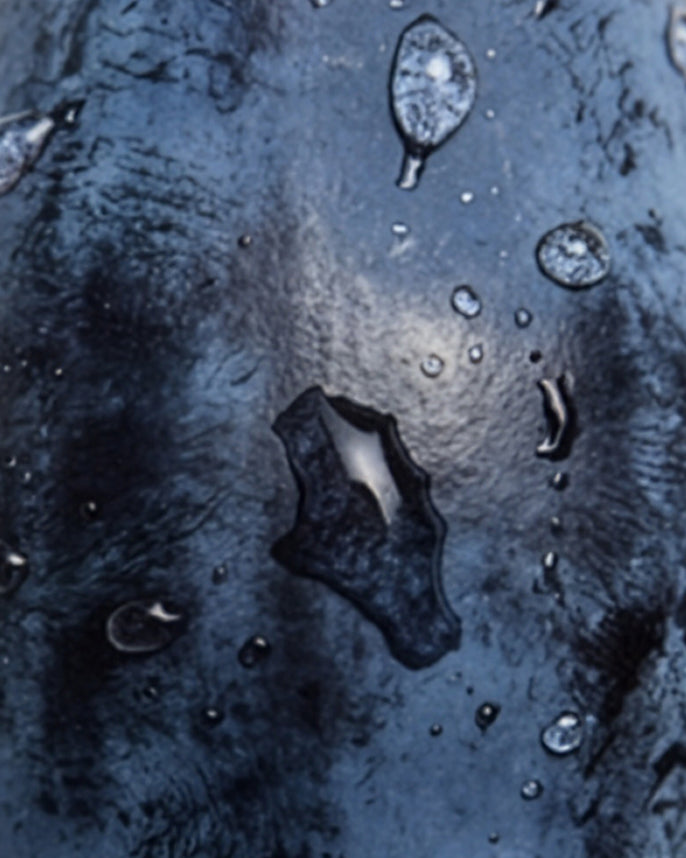 Close-up of water droplets on a textured blue surface