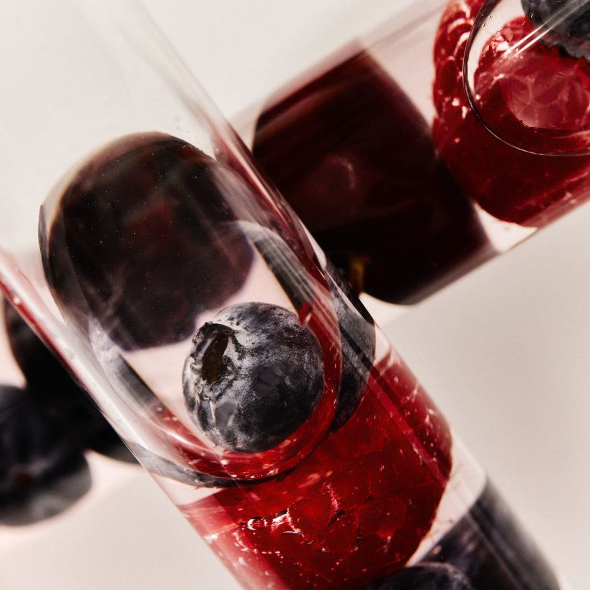 Two clear cases with a blueberry on a white background